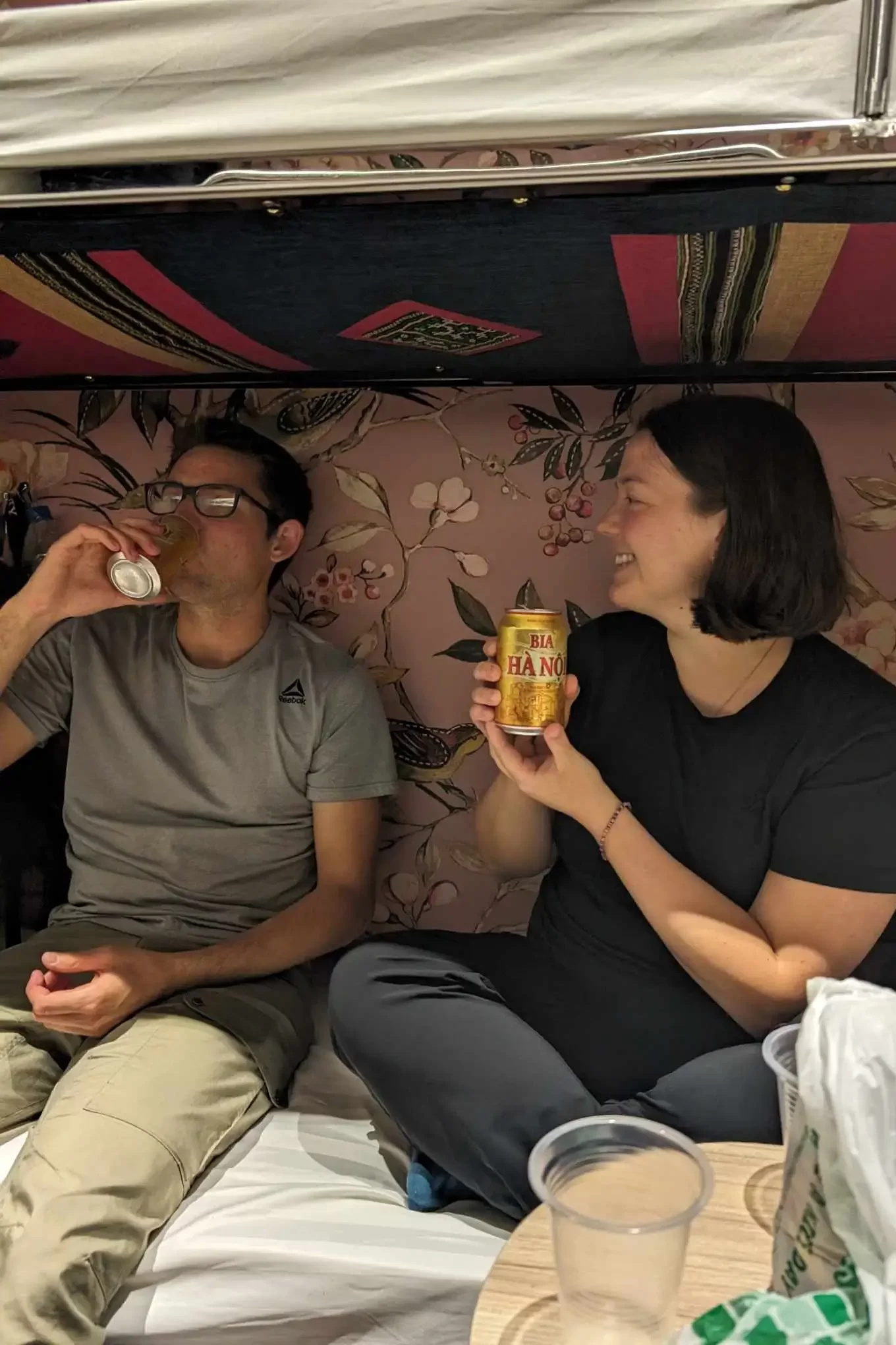 Tanya and her partner, Alex, enjoying an icy Hanoi beer on their overnight train to Hanoi.