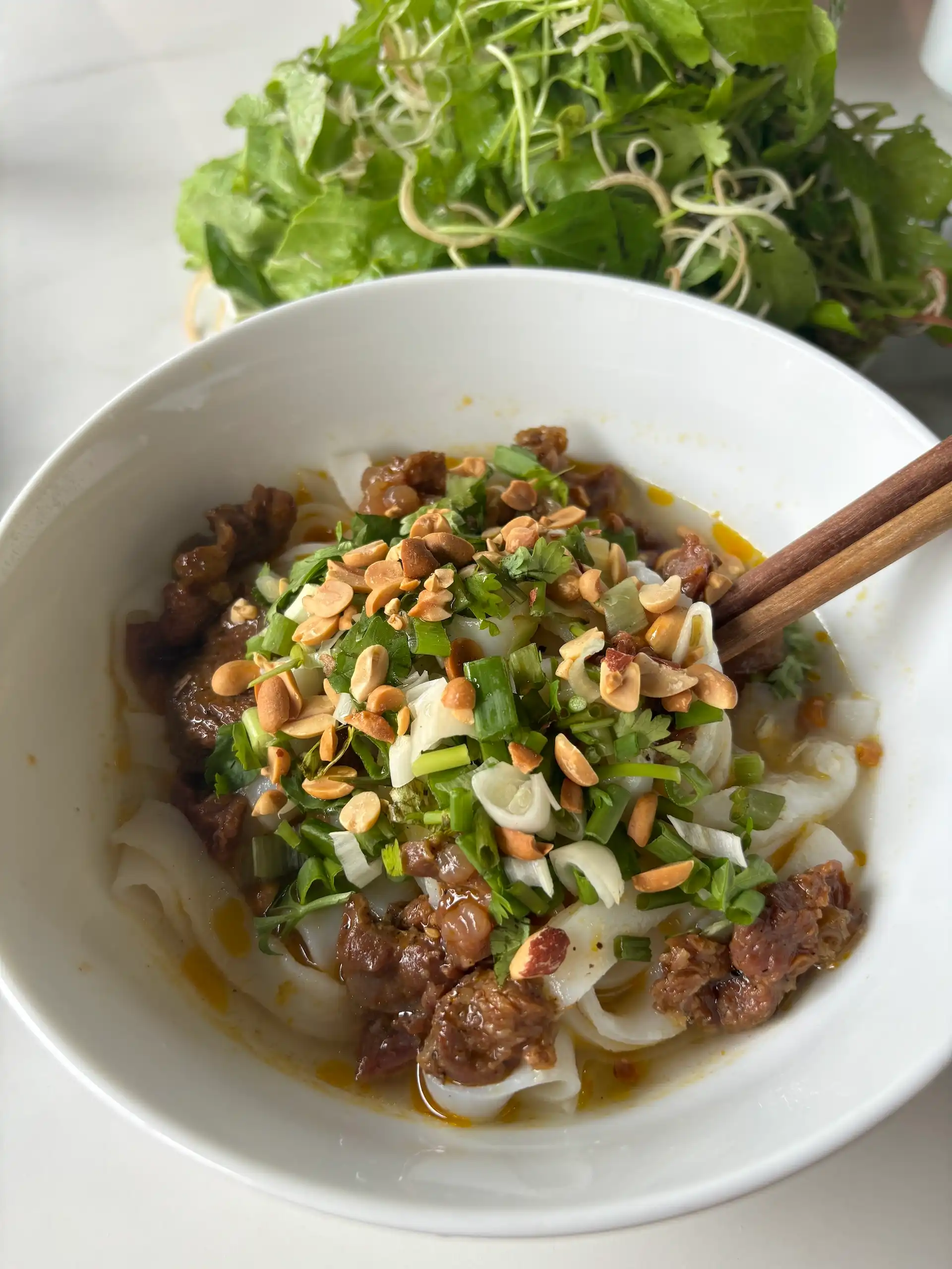 A bowl of mì Quảng turmeric rice noodles