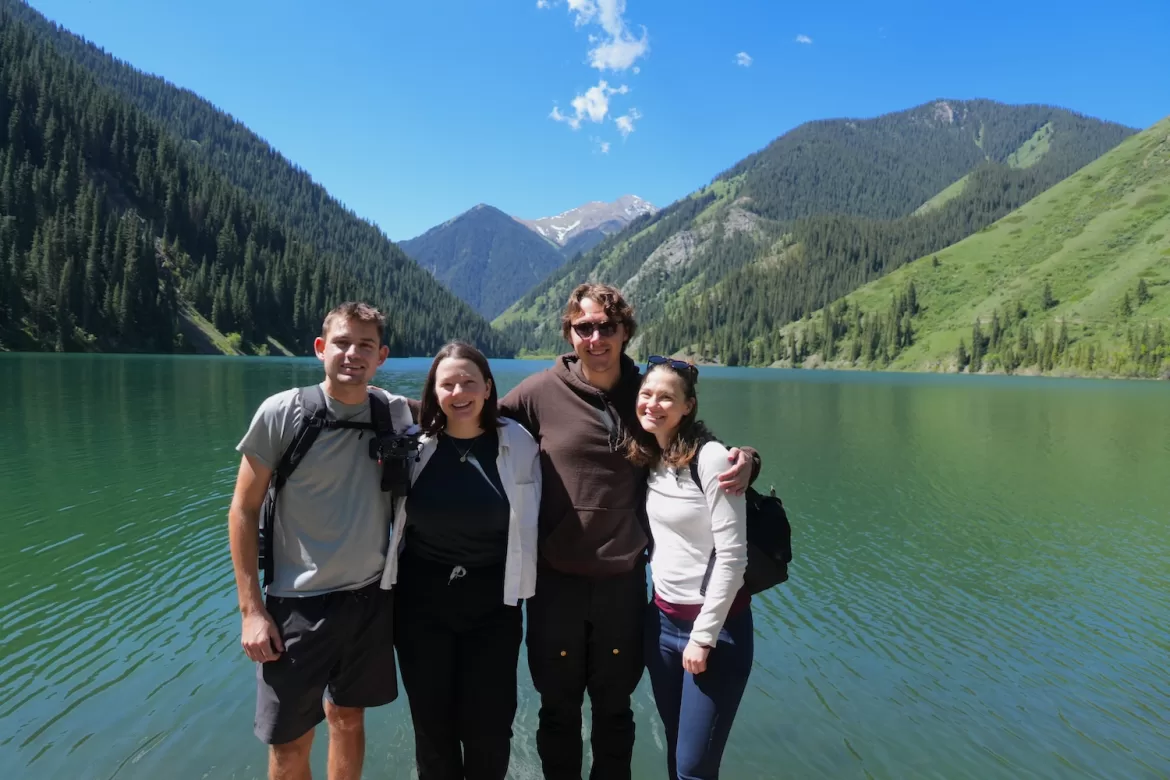 Tanya and her friends posing in front of Kaindy Lake in Kazakhstan while on a day trip together