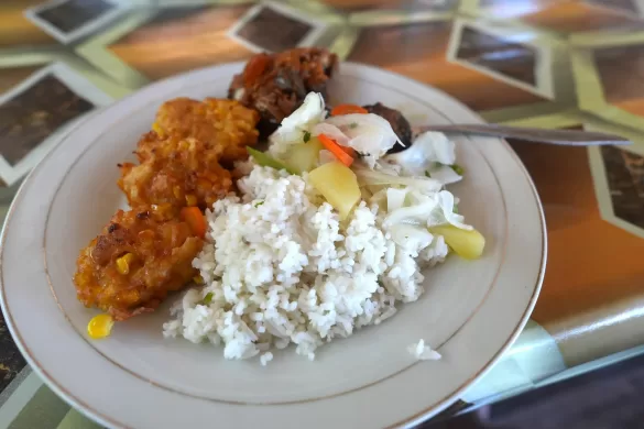 Plate with rice, vegetables, and corn fritters