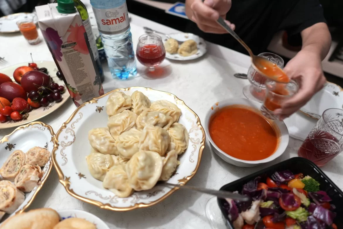 Manti dumplings on a table full of food in Almaty, Kazakhstan