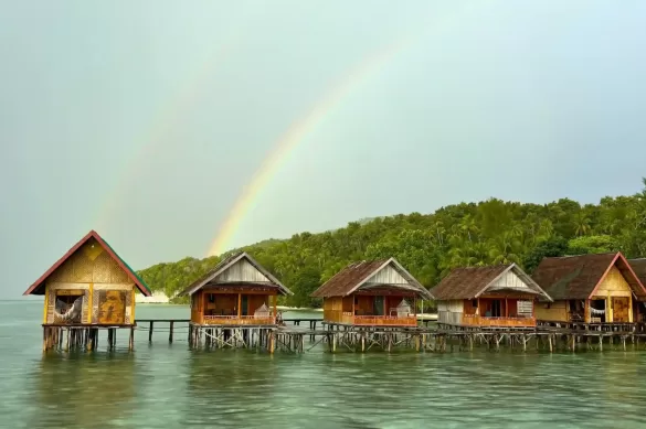 Raja Ampat Kri Yenbuba Homestay after a rain, two rainbows can be seen over the over-the-water bungalows